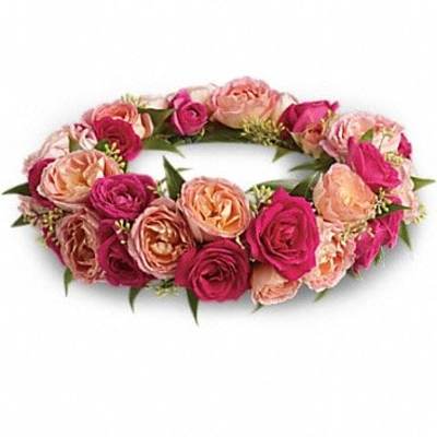 Pink and peach rose wreath arranged in a low circular ring