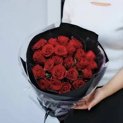 Bouquet of red roses wrapped in black paper