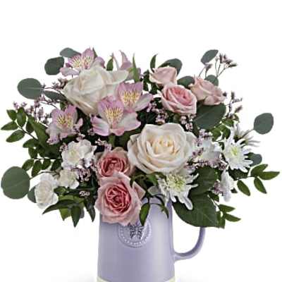 Pastel pink and white mixed bouquet arranged in a lavender ceramic pitcher-style vase