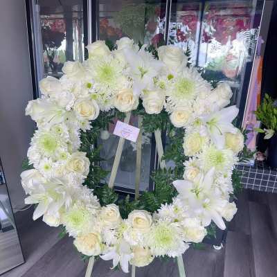 White floral wreath on a standing easel