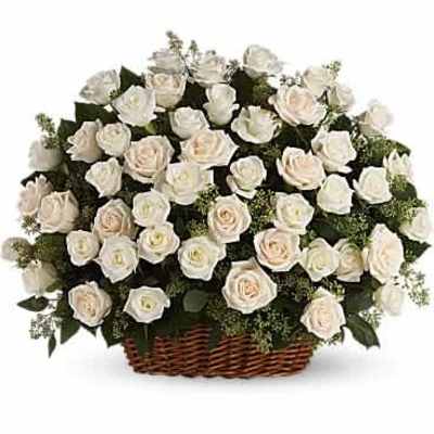 Large arrangement of ivory roses in a brown wicker basket