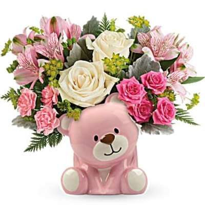 Pink and white flower arrangement in a pink ceramic bear container