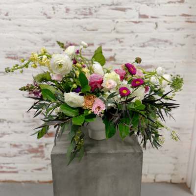 Mixed bouquet in a white vase with pink, white, and purple blooms