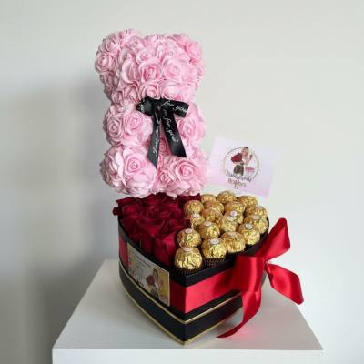 Pink rose teddy bear with red roses and gold chocolates in a heart-shaped box
