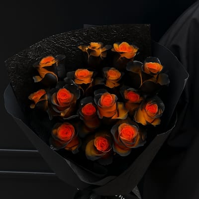 Bouquet of orange roses wrapped in black paper