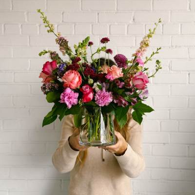 Mixed pink and purple bouquet in a clear glass vase