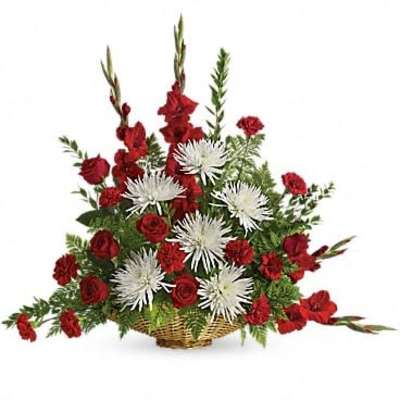 Tall red and white floral basket with roses, carnations, and spiky mums in a woven wicker container