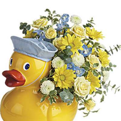 Yellow duck-shaped ceramic container filled with yellow, white, and blue mixed flowers.