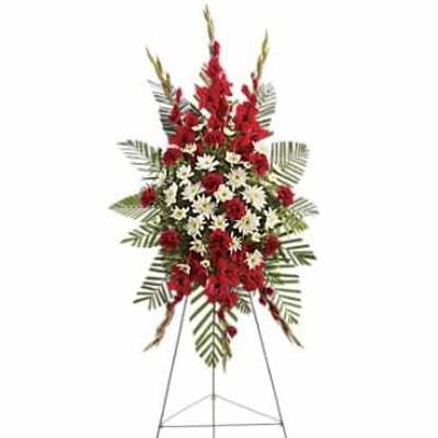 Tall red and white standing spray with carnations and daisies on a metal easel.
