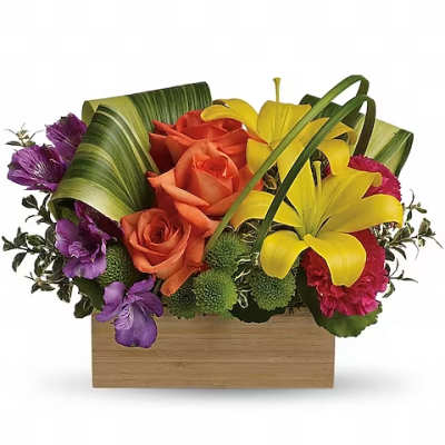 Colorful floral arrangement in a wooden box with roses and lilies