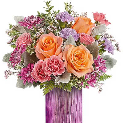 Bouquet of orange and pink roses in a purple glass vase