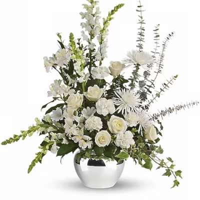 White floral arrangement in a silver vase with tall airy stems