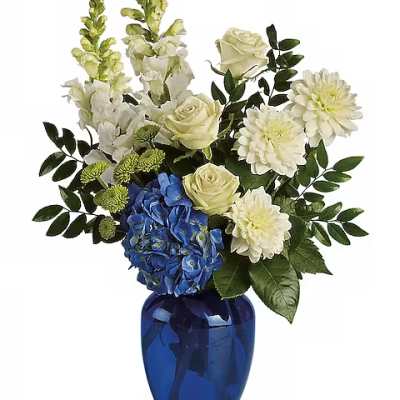 Blue and white floral arrangement in a cobalt vase