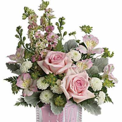 Pastel pink and white flower arrangement with roses and alstroemeria in a pink baby block glass cube vase
