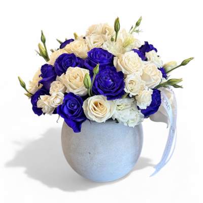 Bouquet of blue and white roses in a round gray vase