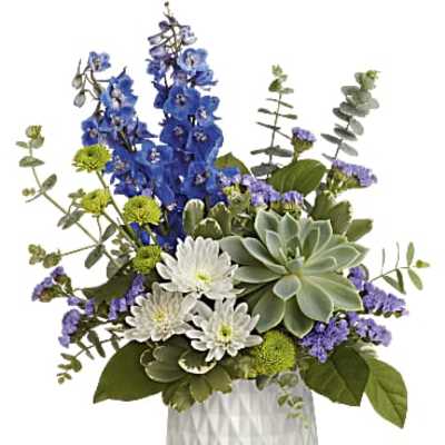 Blue and white floral arrangement in a white textured vase