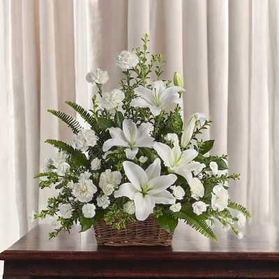 White lilies and carnations in a wicker basket