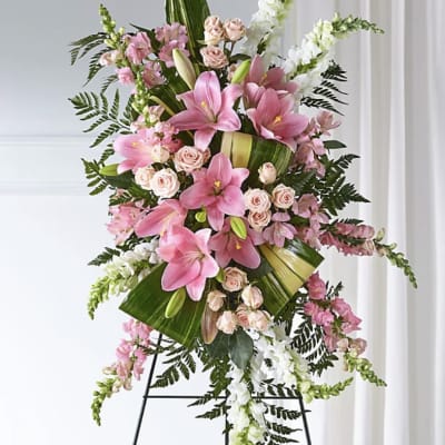 Standing floral spray with pink lilies, roses, and white snapdragons
