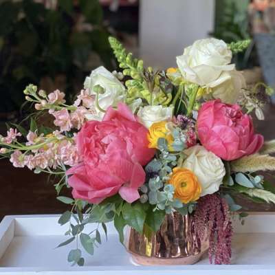Bouquet of pink and white flowers in a copper vase