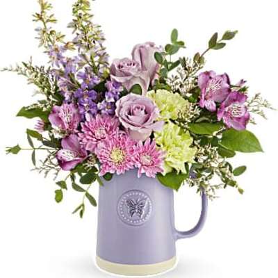 Lavender ceramic mug filled with pastel roses, mums, alstroemeria and mixed spring flowers.
