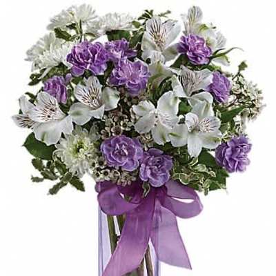 Tall glass vase with white alstroemeria, purple carnations, and white mums tied with a purple ribbon
