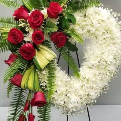 Red roses and white flowers arranged on standing easels