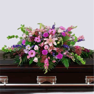 Large pink and purple floral spray on a dark casket