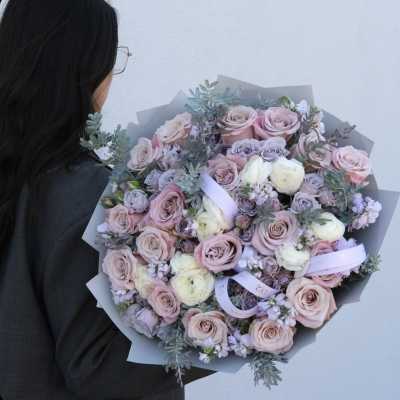 Large bouquet of blush and lavender roses with pale filler flowers