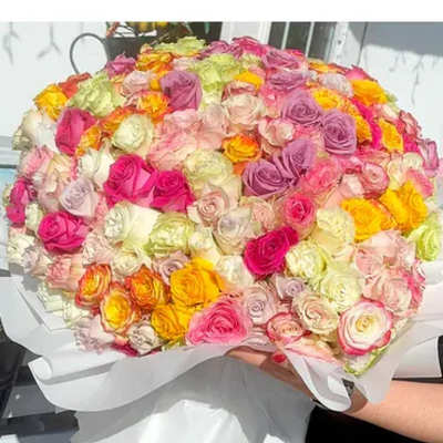 Large bouquet of multicolored roses wrapped in white paper