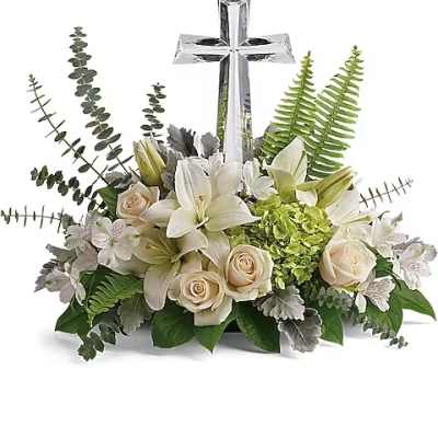 White floral arrangement with a silver cross centerpiece