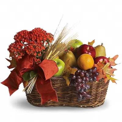 Autumn gift basket with flowers, fruit, and a red ribbon