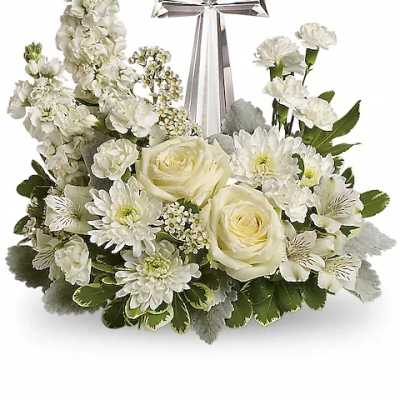 White floral arrangement with a silver cross centerpiece