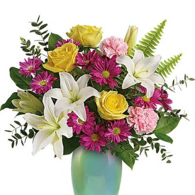 Bouquet of white lilies, yellow roses, pink daisies, and carnations in a green vase
