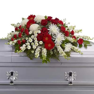 Red and white floral spray on a silver casket