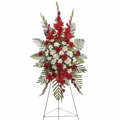 Standing floral spray with red and white flowers on an easel