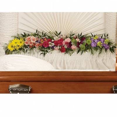 Colorful floral casket spray with roses, daisies, and carnations