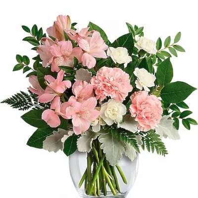 Pink and white flowers arranged in a clear glass vase