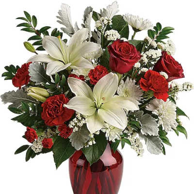 Red roses and white lilies in a red glass vase