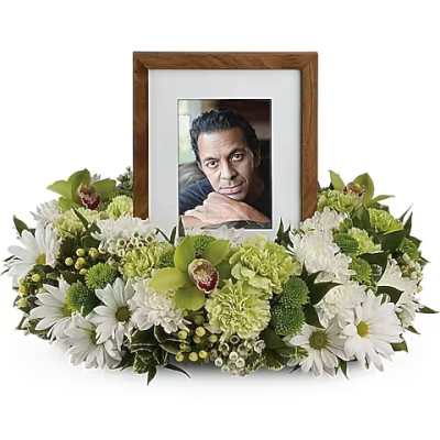 Framed photo surrounded by white and green flowers