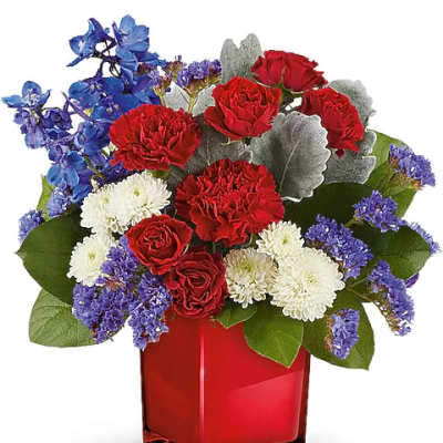 Red roses, white chrysanthemums, and blue flowers in a red vase