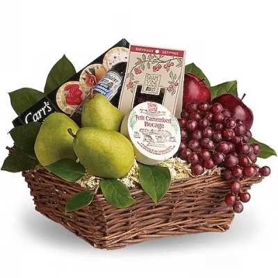 Gift basket with pears, grapes, and cheese in a wicker basket