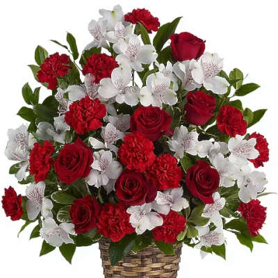 Red roses and white flowers in a woven basket