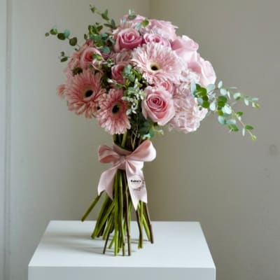 Pink rose and gerbera bouquet tied with a pink ribbon