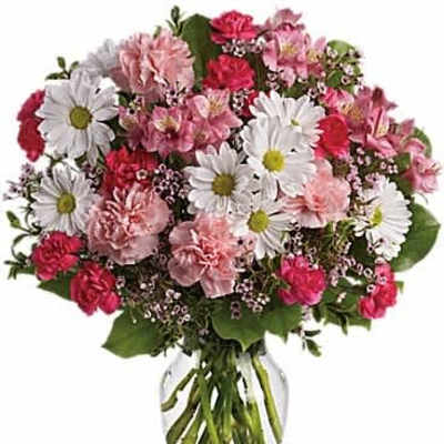 Pink and white mixed flower bouquet with daisies and carnations arranged in a clear glass vase.