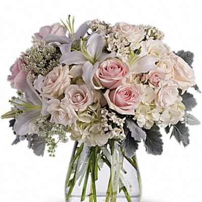 Bouquet of pale pink and white flowers in a clear glass vase