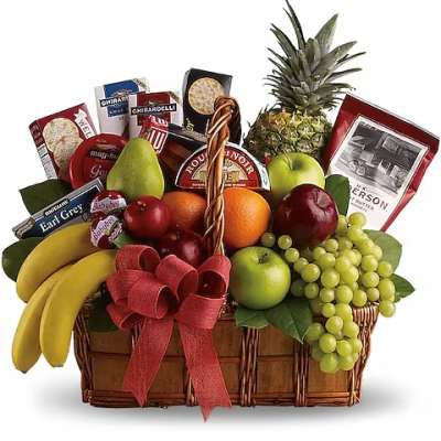 Fruit basket with bananas, grapes, apples, pineapple, and candy boxes