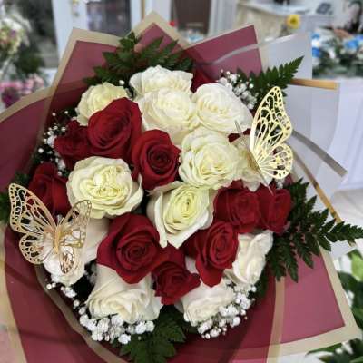 Bouquet of red and white roses with butterfly decorations
