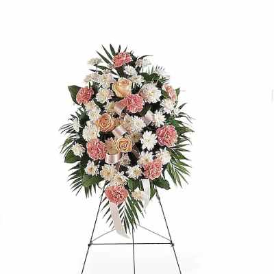 Standing floral spray with pink carnations, white daisies, and peach roses