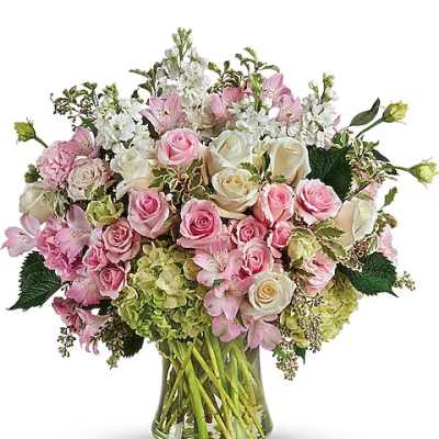 Pink and white rose bouquet in a glass vase