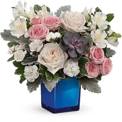 Pink and white roses in a blue glass vase